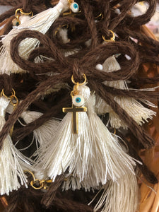 Brown Bow-tied rope with gold cross, ivory tassel, and white and turquoise mati. Comes with straight pin attached in the back. Sold in quantities of 10. #Martyrika