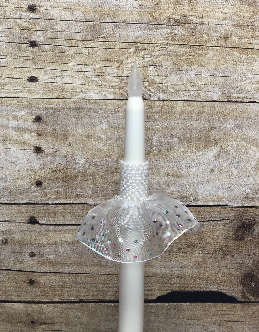 Iridescent pearl strands wrapped around, with iridescent polka dot tutu. Photo is of LED flameless candle.  Also available with regular taper candles